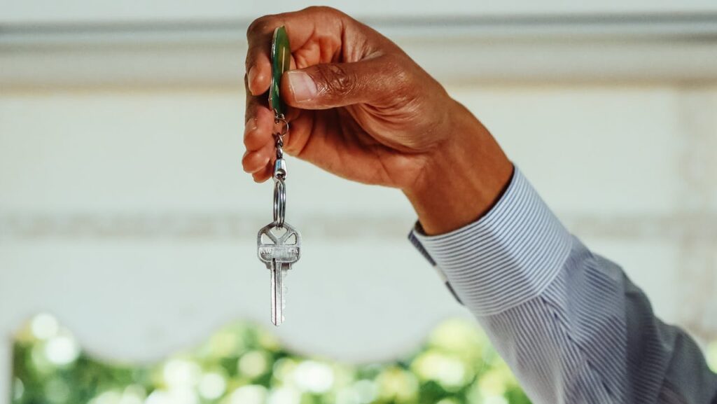 pexels photo 7578975 A hand holding a set of house keys, symbolizing buying or renting a new home.